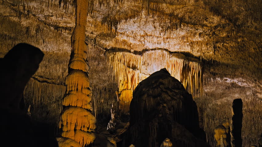 Limestone Underground Cave with stalactites and stalagmites in Majorca, Spain. One of the world's largest caves from stalactites and stalagmites with ancient rocky cavities on the Balearic Islands. Royalty-Free Stock Footage #1108956625