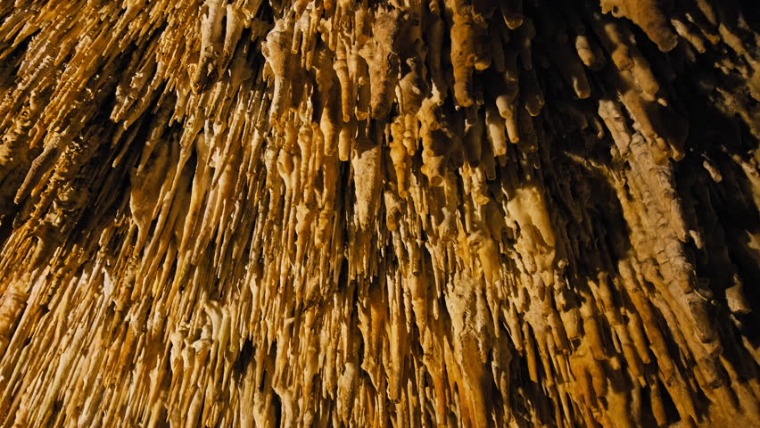 Limestone Underground Cave with stalactites and stalagmites in Majorca, Spain. One of the world's largest caves from stalactites and stalagmites with ancient rocky cavities on the Balearic Islands. Royalty-Free Stock Footage #1108956639