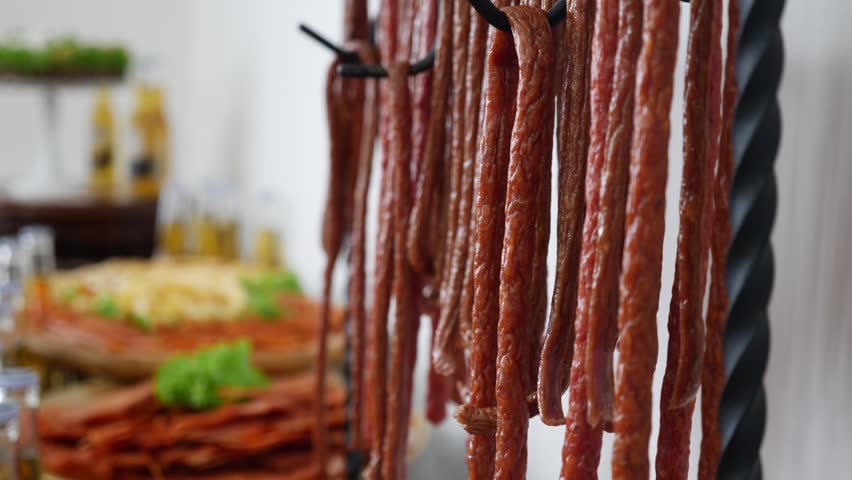 Fried sausages hung on hooks on the buffet table.
