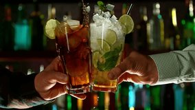 Super slow motion of cheering cocktail drinks in bar. Filmed on high speed cinema camera, 1000 fps. Bar with bottles on background. Ramp speed effect. - Powered by Shutterstock - Get 15% off with code: PIKWIZARD15
