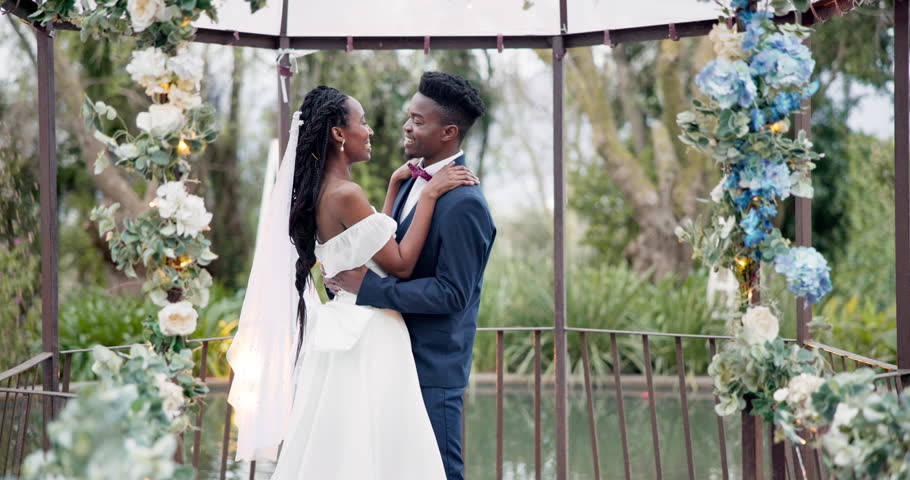 Wedding, dance and kiss with happy black couple in garden with love, celebration and excited for future together. Event, man and woman at marriage reception with flowers, music and happiness at party Royalty-Free Stock Footage #1108963769