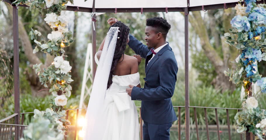 Wedding, first dance and black couple in garden with love, celebration and excited for future together. Gazebo, man and woman at marriage reception with flowers, music and happiness at outdoor party. Royalty-Free Stock Footage #1108963771