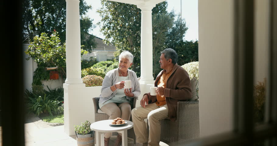 Senior couple, drinking coffee and happy in outdoors, retirement and love for bonding, marriage and trust. Smiling old mexican people, support and relax on porch with food and morning conversation
