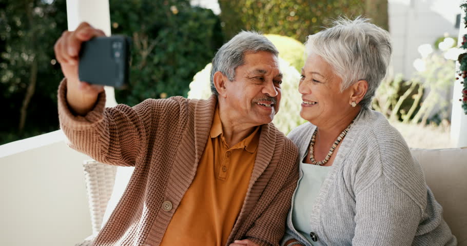 Selfie, happy and a senior couple in a garden for social media, bonding and a memory. Smile, technology and an elderly man and woman taking a photo on a mobile on a backyard home sofa for love