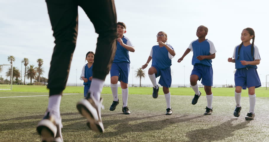Children, leg warm up and sport on soccer field with coach for training and school fitness. Youth, kids and workout for competition in uniform with girl and athlete group with students and exercise Royalty-Free Stock Footage #1108964047