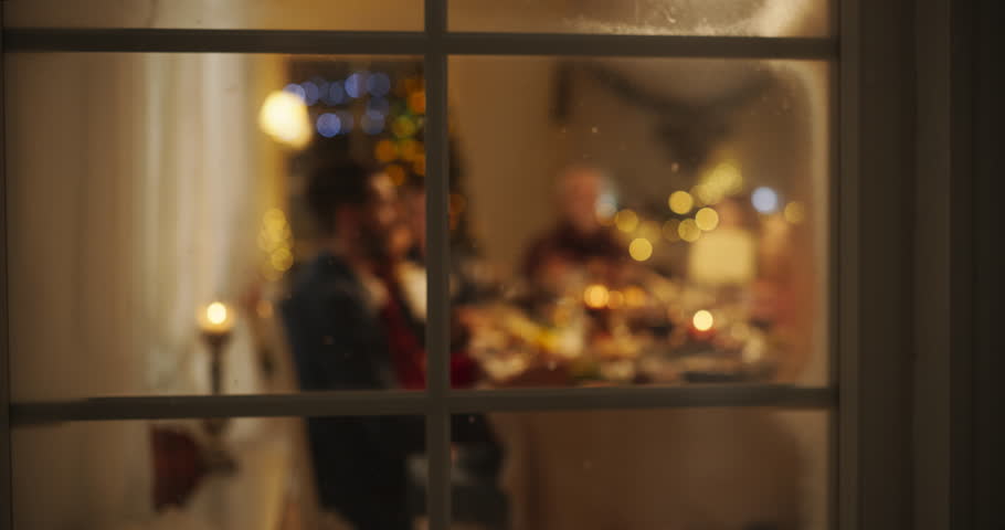 Snowy House Window Footage: Diverse Family Exchanging Christmas Gifts to Celebrate Christmas. Beautiful Old and Young Relatives Excited to Receive Presents. Holiday Dinner Together at Home Royalty-Free Stock Footage #1108964975
