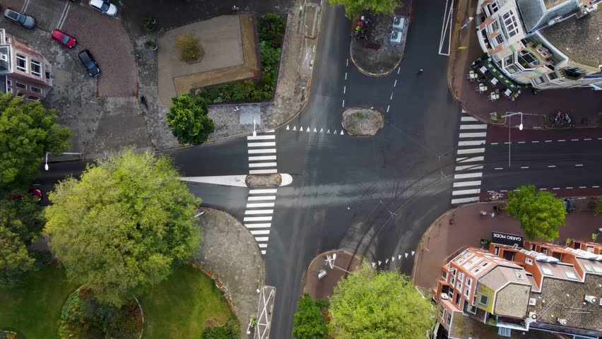 Aerial shot of intersection in The Hague in The Netherlands. Top view (Bird view) of intersection in the city center of The Hague where cars and bus pass by