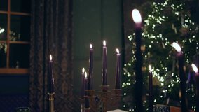 Concept of Christmas and new year taking video closeup the burn candles on the dining table in the living room amazing decorations around
