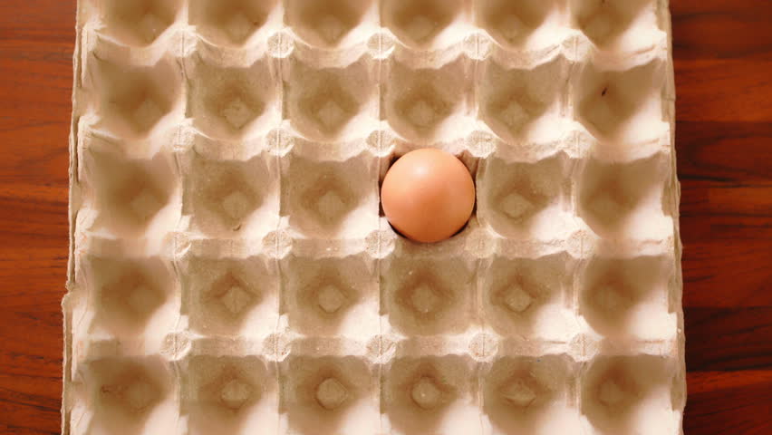 Stop motion. Fresh chicken eggs are placed in cardboard cells on a brown wooden table. Raw chicken eggs for sale at the market. Healthy fresh ingredients for breakfast animal products Royalty-Free Stock Footage #1108969905