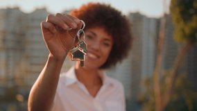 African American woman in city near building skyscraper girl outdoors dwelling accommodation female real estate agency agent showing holding bunch of key from new flat home house development apartment - Powered by Shutterstock - Get 15% off with code: PIKWIZARD15
