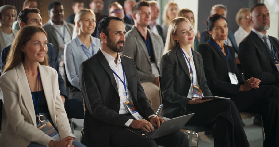 Crowd of Smart Tech People Applauding in Conference Hall During a Motivational Keynote Presentation By Innovative Company. Business Technology Summit Auditorium Room Full of Corporate Delegates. Royalty-Free Stock Footage #1108971047