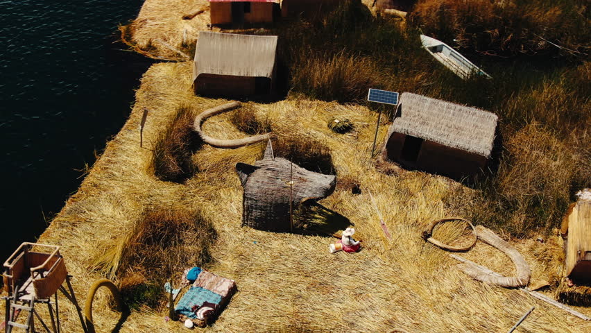 Lake Titicaca, Uros Islands, thatched houses on the island. Heritage of the Incas. The Lost Inca Empire. People live in thatched houses. City of Puno. Straw buildings.