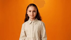 Smiling teen girl dancing against orange background in studio
