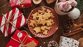 Pastel Christmas decoration on the table with flickering bulbs and hot drink with marshmallow - Powered by Shutterstock - Get 15% off with code: PIKWIZARD15