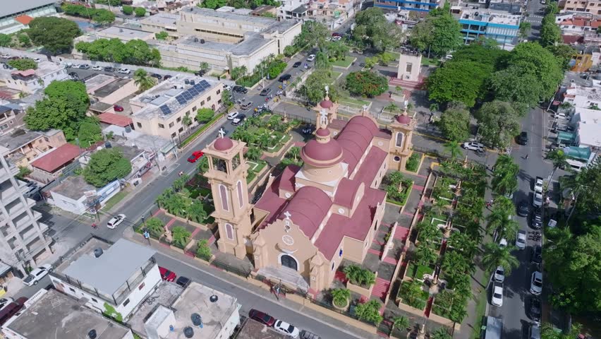 Aerial orbiting shot of ancient cathedral in San Cristobal City on Dominican Republic at summer day