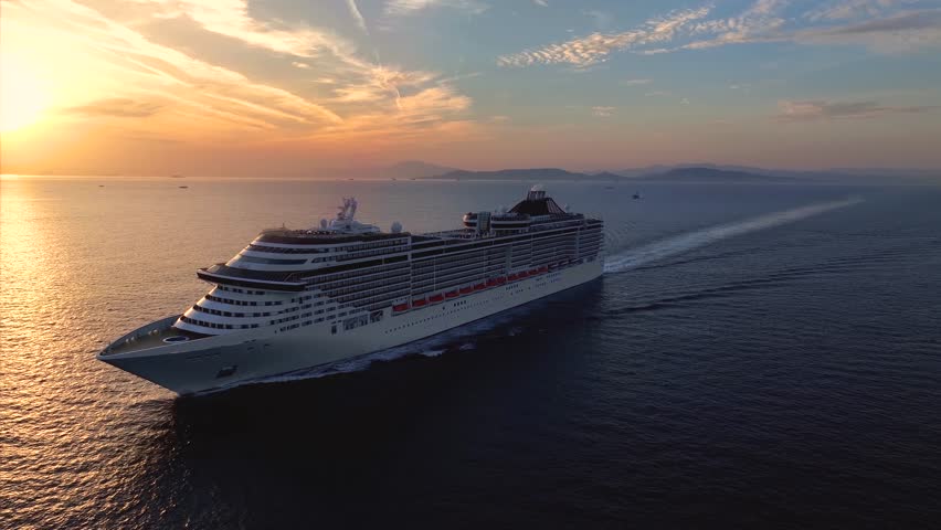 Panoramic aerial view of a cruise ship traveling over the ocean during golden summer sunset time Royalty-Free Stock Footage #1108980551