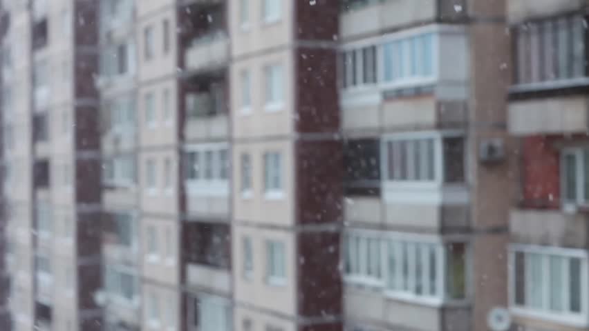Snowfall in the city, snowflakes falling against the background of the windows of the house | Shutterstock HD Video #1108981209