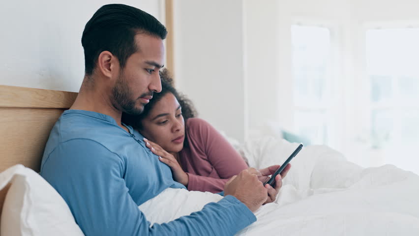 Phone, relax and couple in bed networking on social media, mobile app or the internet at home. Happy, technology and young man and woman scroll on website with cellphone in bedroom of apartment. | Shutterstock HD Video #1108982717