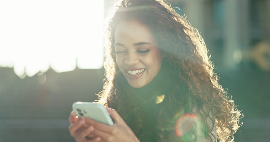 City, funny and woman with a cellphone, typing and digital app with email notification, lens flare and network. Person, outdoor and girl with a smartphone, laughing and connection with social media | Shutterstock HD Video #1108982955