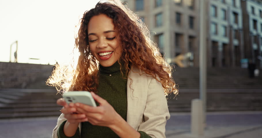 City, funny and woman with a smartphone, typing and social media with connection, lens flare and contact. Person, outdoor and girl with a cellphone, email notification and internet with website info | Shutterstock HD Video #1108982963