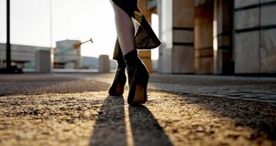 Fashion walking, city and a person in heels in the street for modeling, stylish and chic. Summer, sunshine and ground of a model in trendy shoes in the road or urban city for style or closeup