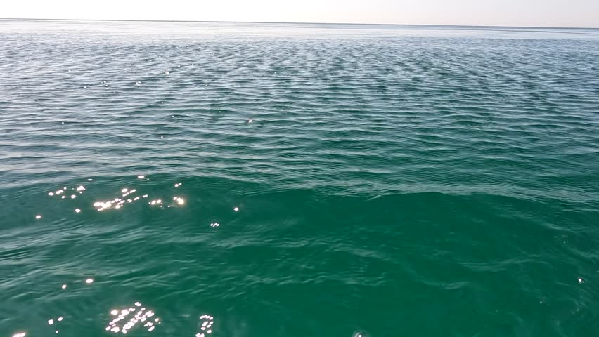 Sea water surface. Low angle view from kayak, camera flies over the clear green sea water. Nobody. Holiday recreation concept. Abstract nautical summer ocean nature. Slow motion. Close up | Shutterstock HD Video #1108986979