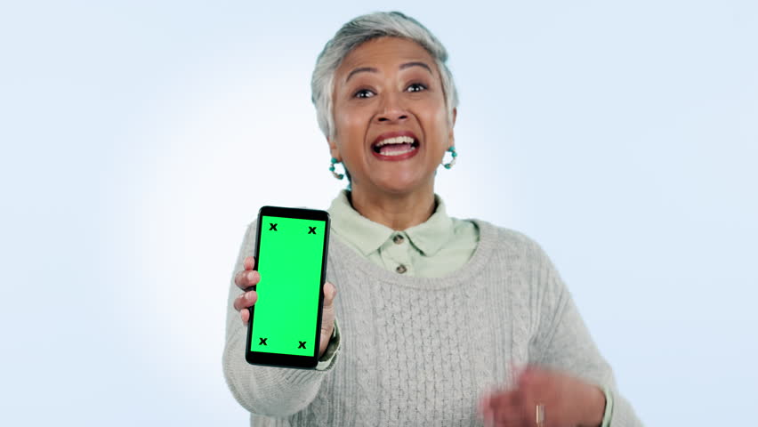 Green screen, phone and senior woman hands show presentation and pointing to app tracking markers on blue background. Easy, steps and person talking with gesture to promotion or info on cellphone | Shutterstock HD Video #1108989577