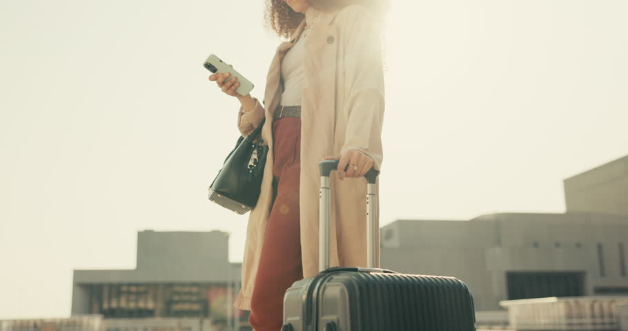 Phone, suitcase and businesswoman walking in the city for company travel or work trip meeting. Technology, luggage and closeup of professional female person networking on cellphone in urban town. | Shutterstock HD Video #1108991637