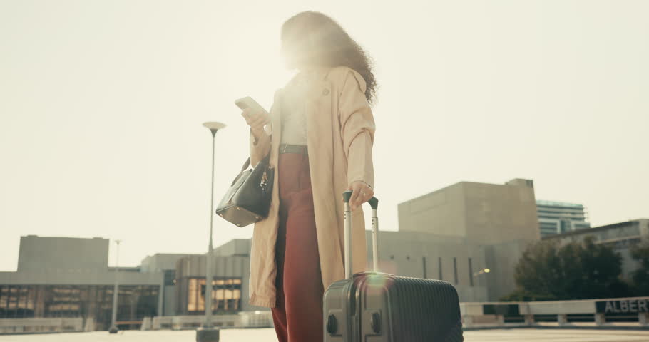 Phone, luggage and businesswoman waiting in the city for company travel or work trip meeting. Technology, suitcase and closeup of professional female person networking on cellphone in urban town. | Shutterstock HD Video #1108991643