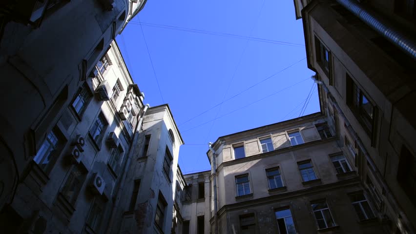 Low angle view of typical well shaped back yard in a sunny summer day in Saint-Petersburg city, Russia. Clear blue sky. Real time handheld video. General architecture theme. | Shutterstock HD Video #1108992629