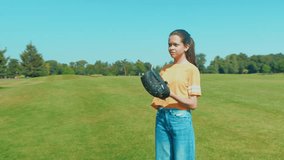 Happy adorable adolescent girl baseball player with glove pitching, training baseball skills and techniques while enjoying leisure and sport activities on green field. - Powered by Shutterstock - Get 15% off with code: PIKWIZARD15