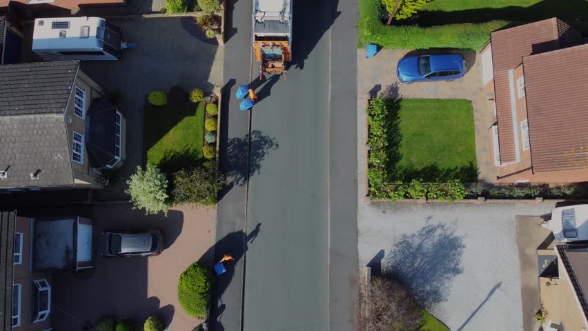Drone 50fps. Waste collection truck in suburban street collecting trash. Filmed. Yorkshire.UK. | Shutterstock HD Video #1108993423