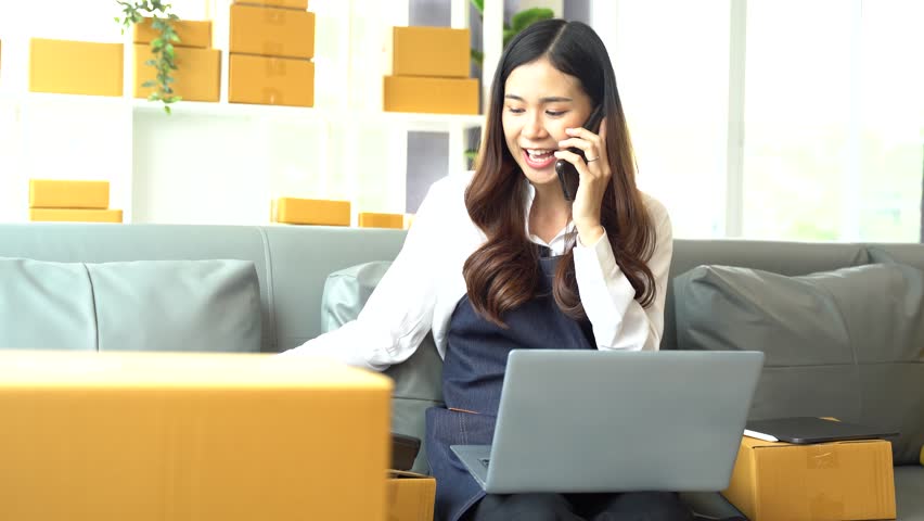 Young asian women using smartphone contacted a customer asking for a shipping address. | Shutterstock HD Video #1108994927
