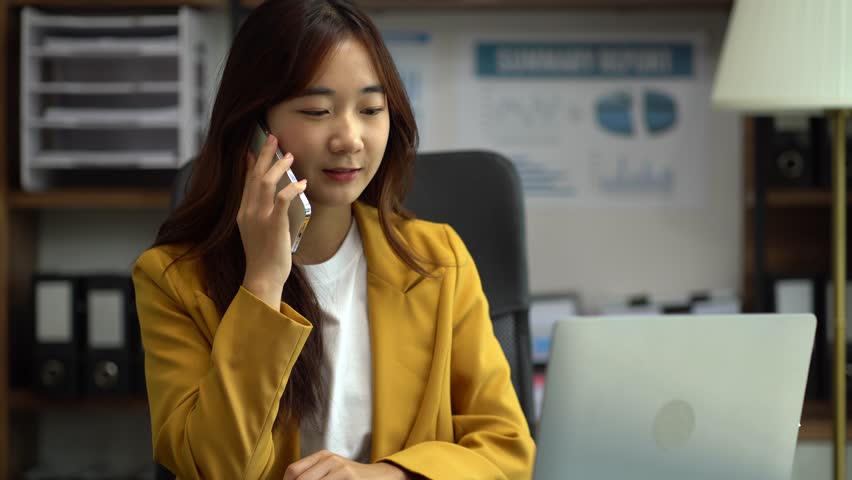 Business women talk mobile phones and working on laptop computers, online business, work from home, teleworking concept. | Shutterstock HD Video #1108994941