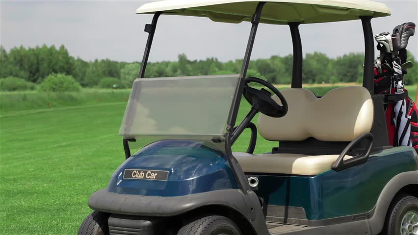 Man and woman sit in golf cart