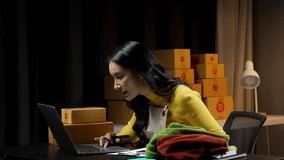 SME owner and Startup small business entrepreneur.Young Asian women using a laptop and packing with box Cheerful success.SME owner Asia people young woman record video,live streaming online at shop.