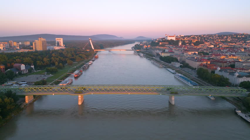 Bratislava slovakia skyline aerial view drone footage of city bratislava bridge and river, bratislava castle view at sunrise icon.