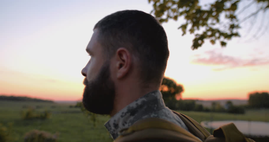 Tracking shot of a homecoming soldier veteran walking towards his house on sunset Royalty-Free Stock Footage #1109007303