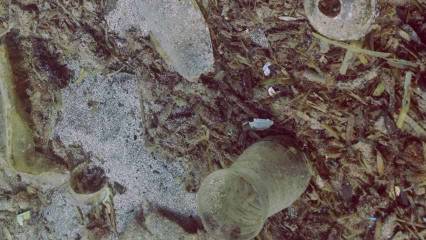 Vertical video, Panorama rock-sand seabed covered with plastic trash and oter debris, Closeup, Slow motion. Concept plastic pollution of Ocean | Shutterstock HD Video #1109009123