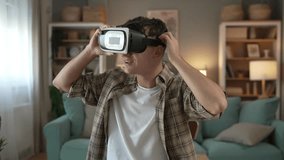 boy caucasian teenager young man student enjoy virtual reality VR headset at home while take a brake - Powered by Shutterstock - Get 15% off with code: PIKWIZARD15