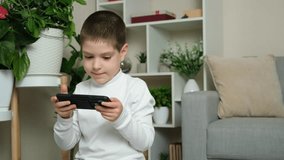 Mom takes away the smartphone from her six-year-old son. Screen addiction in children.