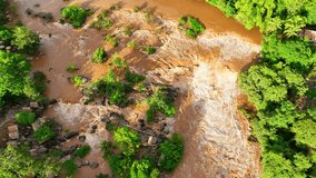 A waterfall flood, when viewed from an aerial perspective, presents a stunning and often devastating scene that showcases the raw power of nature in action. Natural disaster concept.
