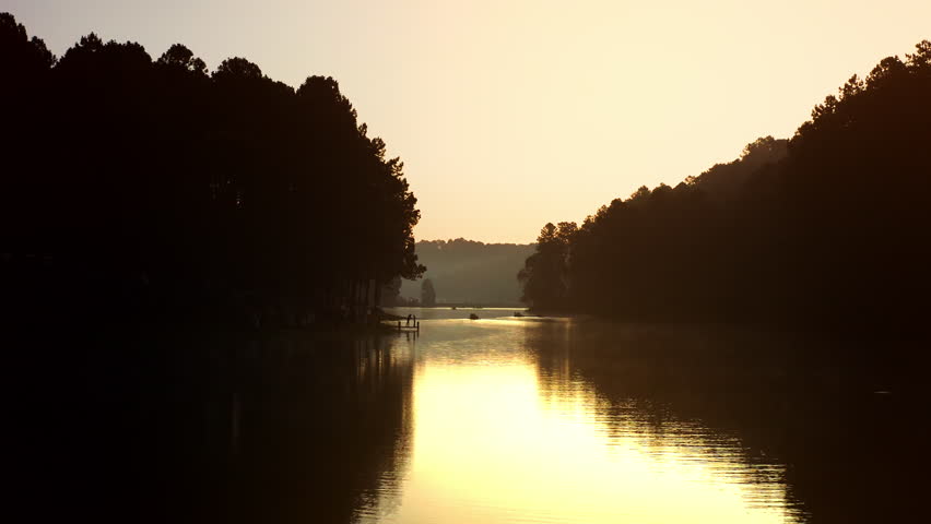 Aerial shot over a lake during sunrise on a lake. Sunrise at Pang Oung Lake in Thailand.