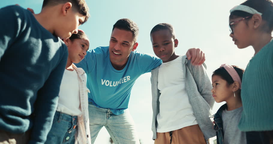Volunteer coach, diversity and teamwork on field for charity event with happiness and collaboration. Children, man and motivation with together for community service, sustainability or sport trainer Royalty-Free Stock Footage #1109021479
