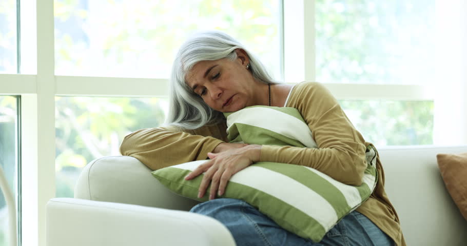 Unhappy, upset mature woman hugs cushion sit on sofa feels desperate suffers from personal troubles, looks frustrated, goes through divorce, break up, marriage split, unpleasant, unfair life situation | Shutterstock HD Video #1109028211