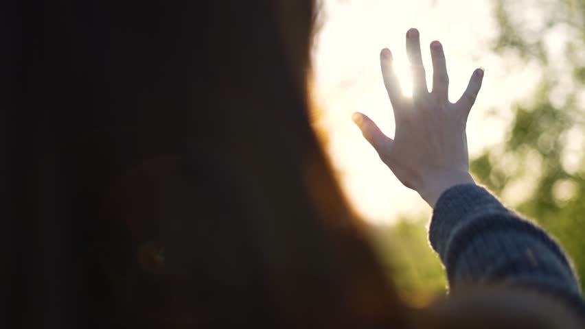 Hand of happy girl at sunset. Sunset between the hands of girl. Happy girl with long hair dreamily stretches out her hand to sun. Child's dream hand to the sun. happy family concept. Freedom in nature Royalty-Free Stock Footage #1109034727