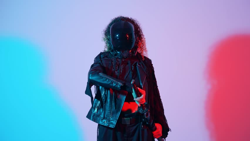 A fashion portrait of a black woman with a Japanese sword shot in a studio with colorful lighting. Ninja and samurai cosplay.