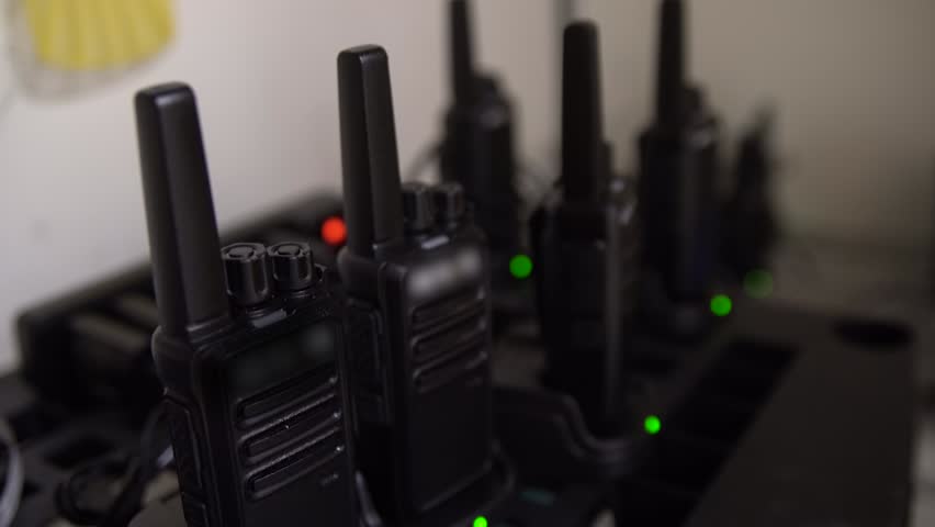 Walkie talkie radio transceiver set up in an office building of a security company. Royalty-Free Stock Footage #1109041821