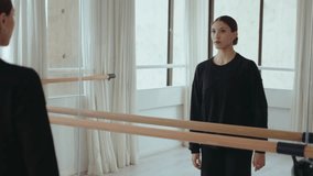 Young artistic female dancer looking at the reflection in mirror wall and performing contemporary dance while rehearsing at the studio - Powered by Shutterstock - Get 15% off with code: PIKWIZARD15
