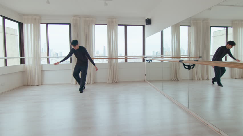 Talented male dancer spinning and practicing floor work, performing expressive contemporary dance alone during rehearsal at the studio Royalty-Free Stock Footage #1109044367